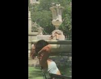 Two guys swim in water fountain park