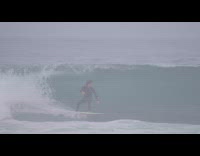 Guy surf waves and fall down beach