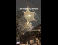 Snowflake lands on mans camera lenses 