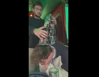 Guy build card tower over drunk friend