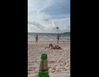 Man poses with German flag on beach