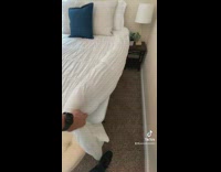 Person lifts bed blanket 