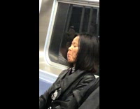 Woman blows up her cheeks and swishes air back and forth in her mouth while closing her eyes on the subway #BluePointWhatTheL