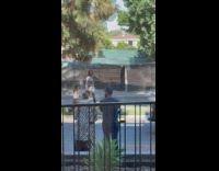 Woman in silver warrior armor on street