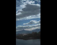 Moving clouds over the river timelapse video