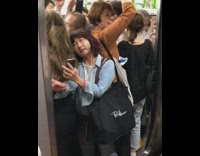 Lady trying to squeeze into closing subway train bag stuck in closing door