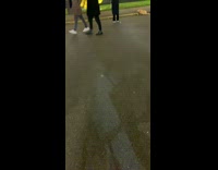 White shirt girl dances by gold disc 