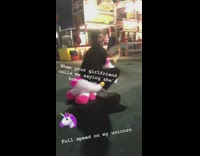 guy in pink and white unicorn at fair