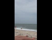 Black bikini girl crawls lays back beach 