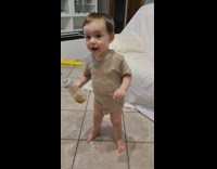 Young boy hold bottle burps grey shirt