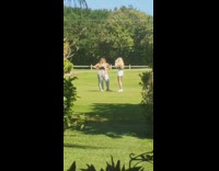 Grey sweatpants two girls grass field 