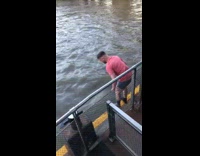 Guy jumps into the river from dock and current takes him away