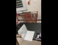 girl in pink falls off orange shopping cart classroom