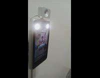 Guy holds photo up camera thermometer screen