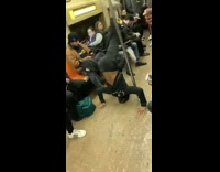 Subway dancer does headstands and performs on subway train