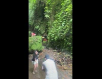 Woman red onesie pose over large rock forest