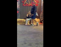 Collab IITW - Woman stream and eats corndog on fair