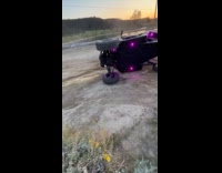Woman turns ATV flipped down on ground
