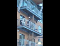 Guy striped shirt picture on balcony rail