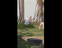 Man in white shirt motivational video shoot at the beach