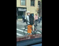 Collab WINY - Man white cap yellow shorts on bicycle with dog on backpack