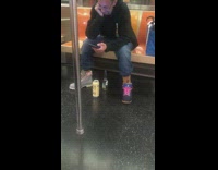 Guy Laughs at Video with Beer Bottles Below 