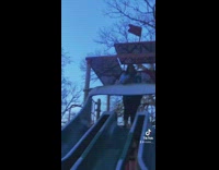 Big woman goes down small slide