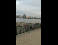 Guy silver jacket dance on rock shore