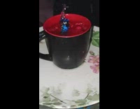 Guy drops battery in mug with water  