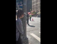 Man sings and rides bike on street