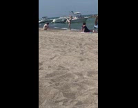 Woman black bikini ballerina pose at the beach