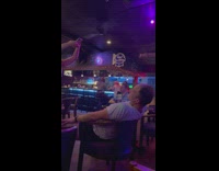 Man in white shirt sexy dance inside the bar