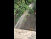 Slight rainbow effect from water sprayed from building