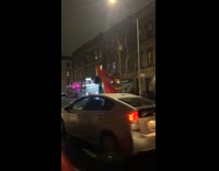 Collab WINY - Person red tall costume scares car that passes