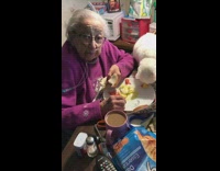 Grandma shares breakfast with cat