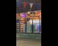 Grey sweater guy sits chair stacked boxes