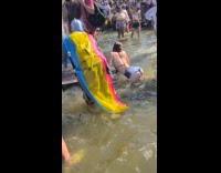Woman twerks at fountain during pride celebration