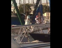 Two women dance on a boat 