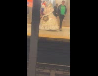 Woman dressed as Asian doll in subway