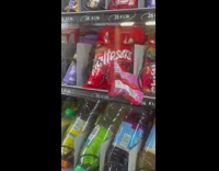 Girl tries to get stuck bag of skittles 