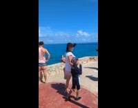 Collab IITW - Woman in bikini lay on stone ledge while other people passing by