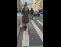 Couple rides on one scooter along street in NYC 