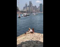 Woman lay on ledge opera house boat