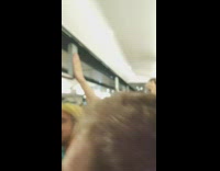 Subway passengers sing song together in another language on subway train