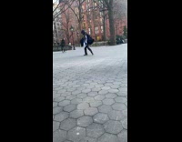 Guy wearing poncho jumps and dances outside 
