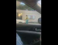 Lady uses gas station squeegee to clean hood