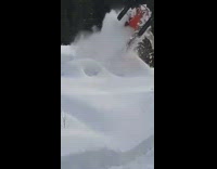 Men in Snowmobile Jumps on Snow Ramp