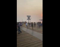 Man white tank top Santa Monica signage