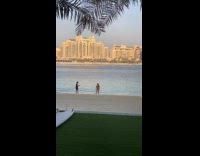Girl black bikini handstand beach dubai buildings