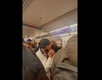 Guy performs christmas carol with hands and wishes happy holidays